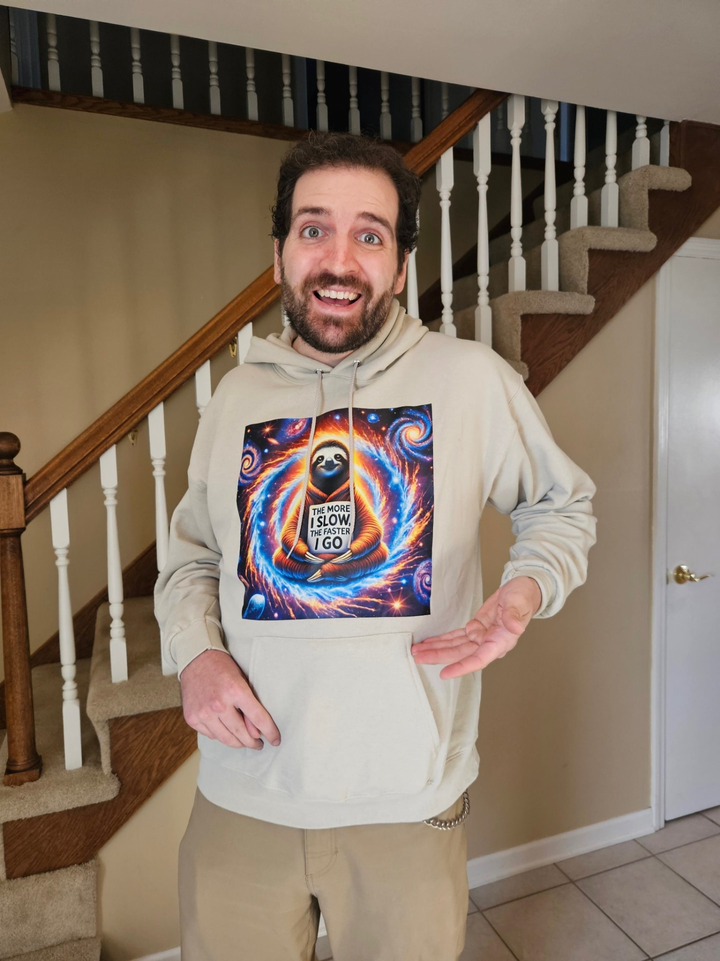 Elliott smiling at home in a cosmic sloth hoodie